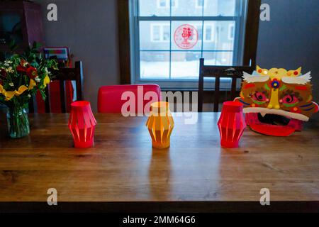 Table with paper lanterns and Chinese Lion for Lunar New Year Stock Photo