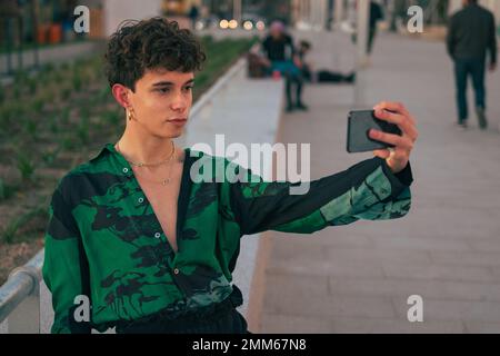 Stylish gay man take a selfie with his mobile phone on the street Stock Photo