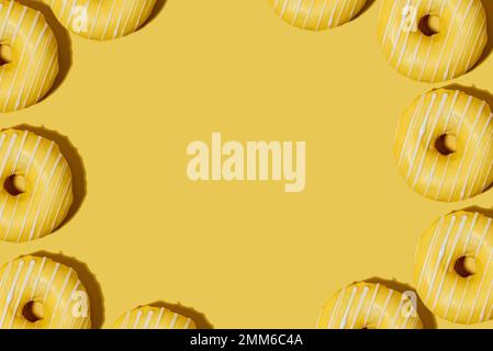 lemon doughnut in yellow glaze on a yellow background. pattern. Stock Photo