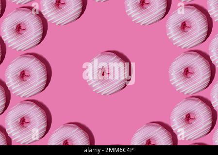 raspberry donut in pink glaze on a pink background. pattern. Stock Photo