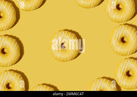 lemon doughnut in yellow glaze on a yellow background. pattern. Stock Photo
