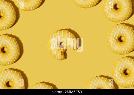lemon doughnut in yellow glaze on a yellow background. pattern. Stock Photo