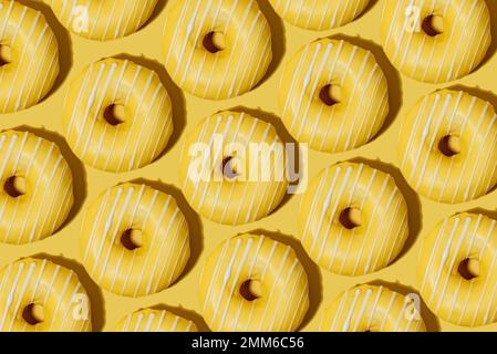 lemon doughnut in yellow glaze on a yellow background. pattern. Stock Photo