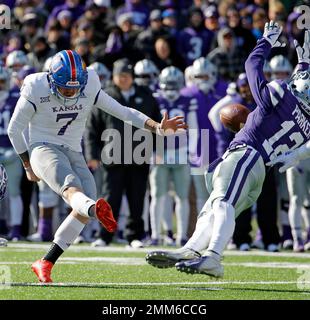 LAWRENCE, KS - SEPTEMBER 09: Central Michigan Running Back Kumehnnu Gwilly  (33) break through the tackle of Kansas Safety Bryce Torneden (1) during  the game between Central Michigan and Kansas on Saturday