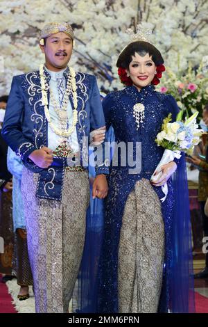 a wedding procession with Javanese tradition. The bride wears traditional Javanese dress.. Stock Photo