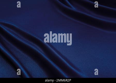 Texture of a smooth luxurious, elegant fabric in burgundy, purple, blue. blue satin or silk fabric with folds and waves Stock Photo