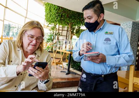 Mexico City,Bosque de Chapultepec Section 2 Forest,Del Bosque Restaurante,Del Bosque Restaurante,writing taking order,customer reading digital emenu m Stock Photo