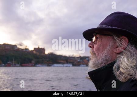 Side view of man wearing glasses against sea Stock Photo