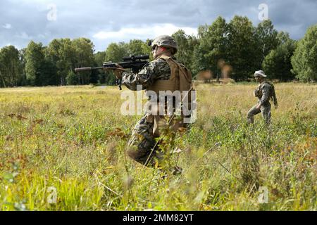 U.S. Marine Corps Pfc. Robert Prozzillo, automatic rifleman, 1st Battalion, 8th Marine Regiment, 2d Marine Division, covers his sector while conducting a live fire and movement range during exercise Archipelago Endeavor 22 (AE22) on Berga Naval Base, Sweden, Sept. 14, 2022. AE22 is an integrated field training exercise that increases operational capability and enhances strategic cooperation between the U.S. Marines and Swedish forces. Stock Photo