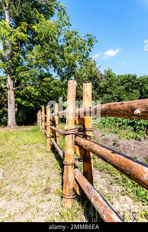 Fence made of natural wooden poles at the countryside in summer Stock ...