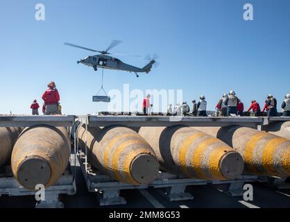 220915-N-VS068-1073    PACIFIC OCEAN (Sept. 15, 2022) – An MH-60S Sea Hawk assigned to the Helicopter Sea Combat Squadron (HSC 21) drops off ordinance during an ammunition onload aboard amphibious assault ship USS Makin Island (LHD 8), Sept. 15 Aviation Ordnancemen operate and handle aviation ordnance equipment and are responsible for the stowage and loading of munitions and small arms. The Makin Island Amphibious Ready Group, comprised of amphibious assault ship USS Makin Island (LHD 8) and amphibious transport docks USS Anchorage (LPD 23) and USS John P. Murtha (LPD 26), is underway conducti Stock Photo