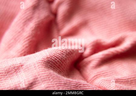 pink crumpled fabric as a background macro photo, pink background Stock Photo