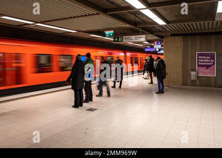 People waiting for an arriving metro train in Rautatientori metro station, Helsinki, Finland Stock Photo