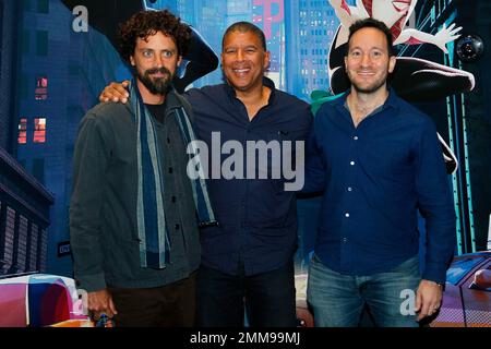 Directors Rodney Rothman, right, Peter Ramsey, center, and Robert Persichetti poses for photographers during a photocall for the presentation of 'Spider-Man: Into the Spider-Verse' during the Comic-Con, in Paris, Saturday, Oct. 27, 2018. (AP Photo/Thibault Camus)