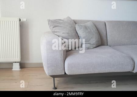 modern grey sofa with pillows in living room at home Stock Photo