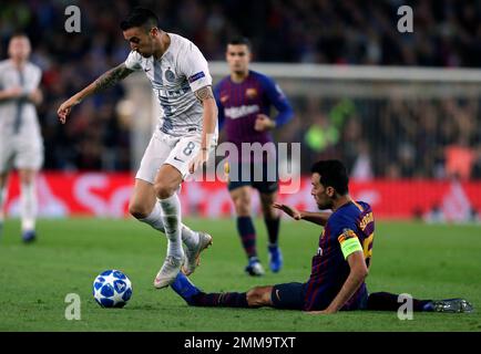 Barcelona midfielder Sergio Busquets heads the ball over AC Milan  midfielder Kevin Prince Boateng, of Ghana, during a Champions League first  leg quarterfinals soccer match, between AC Milan and Barcelona, at the