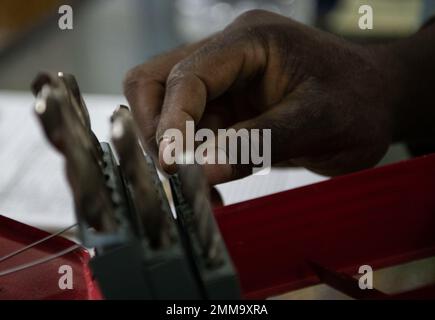 U.S. Air Force Senior Airman Cameron Walker, 386th Expeditionary Civil Engineer Squadron inventory technician, checks drill bits before checking them out to a customer at the U-Fix-It building on Ali Al Salem Air Base, Kuwait, September 15, 2022. The U-Fix-It store supplies Airmen with anything they may need for self help projects around base. Ali Al Salem,Cameron Walker,DEPLOYMENT,ECES,Kuwait,U-fix it, Stock Photo