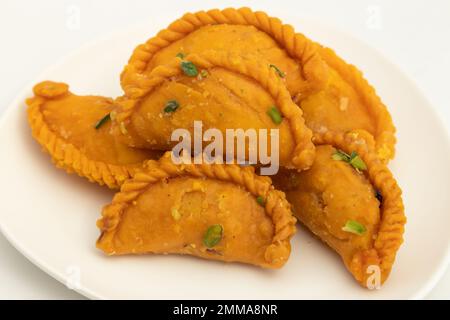 Kesar Gujia Mithai Also Called Kesri Gujiya, Pirukiya, Pirukia, Pedakiya, Karanji, Basundi Gughra Made Of Suji Ghee Stuffed With Mawa Khoya Kesari Cha Stock Photo