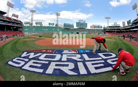 Members of the grounds crew paint the World Series logo on