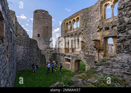 Summer hall inside with arcades, windows and chimney consoles, behind castle tower western keep, tourists on guided tour, castle ruins medieval Stock Photo