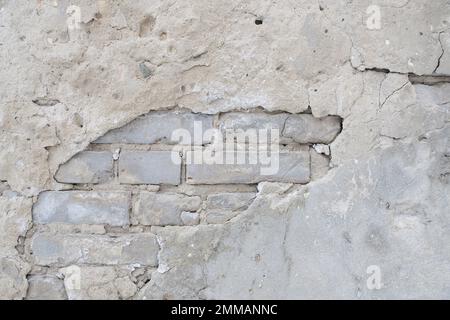 Old brick wall with peeling plaster Stock Photo