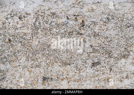 Old, gray concrete wall with peeling white paint Stock Photo