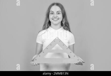 cheerful child with math triangle measuring tool Stock Photo