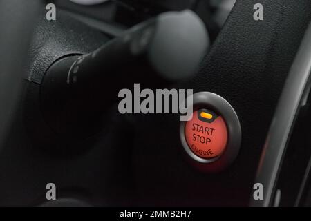 Close up of the red illuminated ignition button of a modern car. Stock Photo