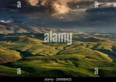 Sunset on hills in Caucasus mountains Stock Photo