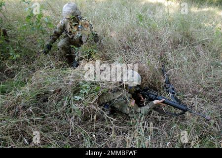 Army soldiers camouflaged in grass with weapons during Basic Combat Training, Fort Sill, Oklahoma, 2016 - photo by Cindy McIntyre Stock Photo