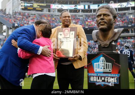 Hall of Fame linebacker Robert Brazile holds his Tennessee Titans