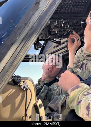 U.S. Army Chief Warrant Officer 2 Christopher Hansen, a Clifton Park, NY, native, UH-60M Black Hawk Pilot and Aviation Mission Survivability Officer for Alpha Company, 3-142nd Assault Helicopter Battalion (AHB), based out of Latham, New York, performs start-up procedures of a UH-60M Black Hawk at Camp Buehring, Kuwait, Sept. 16, 2022. Hansen and his crew surveyed landing zones in the vicinity of Camp Buehring during their flight. 3-142nd AHB, attached to 36th Combat Aviation Brigade, currently supports the Combined Joint Task Force - Operation Inherent Resolve mission to advise, assist, and en Stock Photo