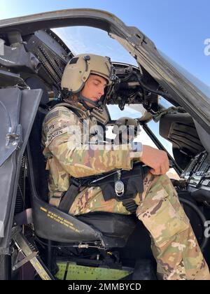 U.S. Army Chief Warrant Officer 2 Christopher Hansen, a Clifton Park, NY, native, UH-60M Black Hawk Pilot and Aviation Mission Survivability Officer for A Company, 3-142nd Assault Helicopter Battalion (AHB), based out of Latham, New York, reads from a checklist during start-up procedures of a UH-60M Black Hawk at Camp Buehring, Kuwait, Sept. 16, 2022. Hansen and his crew surveyed landing zones in the vicinity of Camp Buehring during their flight. 3-142nd AHB, attached to 36th Combat Aviation Brigade, currently supports the Combined Joint Task Force - Operation Inherent Resolve mission to advis Stock Photo