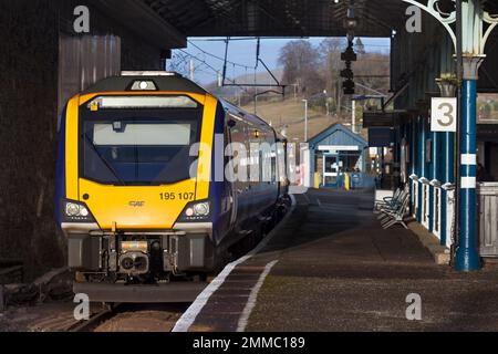 Northern Rail CAF class 195 train at Oxenholme the Lake District railway station waiting to depart with a Windermere branch train Stock Photo