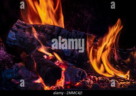 oak wood burning inside a fireplace with orange flames images of autumn and winter in the warmth of the home Stock Photo