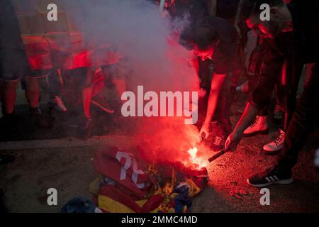 Far-right demonstrators burn Catalan independence flags and banners during Spain's National Day celebrations in the Catalan city of Barcelona, Spain, Friday, Oct. 12, 2018. Catalan leaders, who are demanding independence for the wealthy northeastern region stayed away from ceremonies in Barcelona. (AP Photo/Felipe Dana)