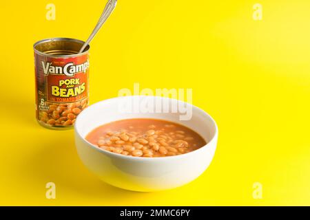tin of Van Camps Pork and Beans Baked Beans stand out  on a yellow background in a white bowl Stock Photo