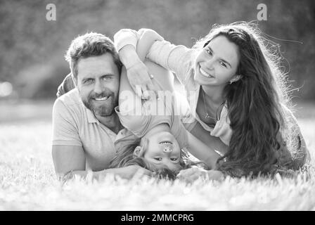 friendly family having fun in summer. happy parents with kid boy. mom dad and son love relax Stock Photo