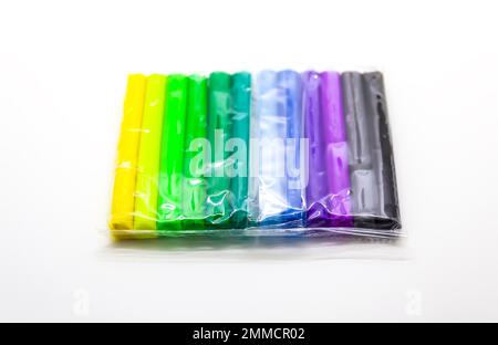 Multicolored plasticine set in a plastic package on a white background Stock Photo