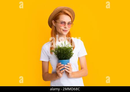 Woman planting flowers in pot. Gardening, flower planting concept. Woman or gardener planting flower pot. Stock Photo