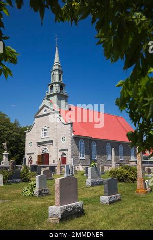 Cemetery and Saint-Jean church in summer, Saint-Jean, Ile d'Orleans, Quebec, Canada. Stock Photo