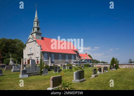 Cemetery and Saint-Jean church in summer, Saint-Jean, Ile d'Orleans, Quebec, Canada. Stock Photo