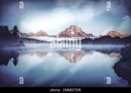 Mount Moran reflects in the still waters at Oxbow Bend of the Snake River in Grand Teton National Park in Wyoming. Stock Photo