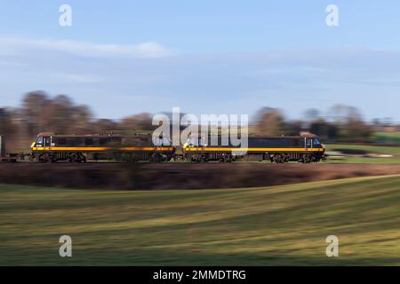 2 DB Cargo rail UK class 90 electric locomotives90020 + 90026 panned at speed on the west coast mainline with a freight train Stock Photo