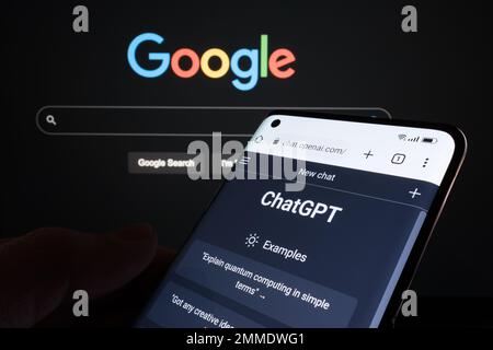 ChatGPT chat bot page seen on smartphone and laptop display with blurred GOOGLE search page. AI chatbot vs search engine. Concept. Stafford, United Ki Stock Photo