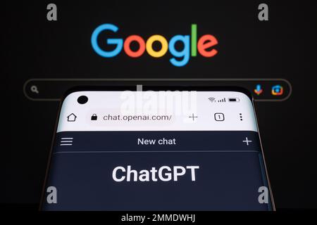 ChatGPT chat bot page seen on smartphone and laptop display with blurred GOOGLE search page. AI chatbot vs search engine. Concept. Stafford, United Ki Stock Photo