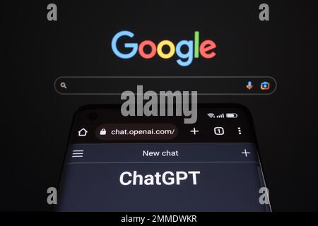 ChatGPT chat bot page seen on smartphone and laptop display with blurred GOOGLE search page. AI chatbot vs search engine. Concept. Stafford, United Ki Stock Photo