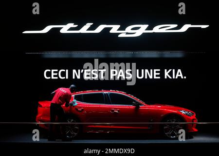 A man polishes a KIA Stinger during the Auto show in Paris, France, Tuesday, Oct. 2, 2018, 2018. (AP Photo/Thibault Camus)