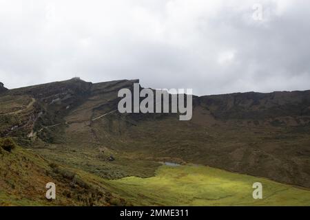 Beautiful colombian paramo ecosystem landscape with andean mountain range at background and a green valleyBeautiful colombian paramo ecosystem landsca Stock Photo