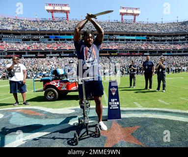 Wounded Warrior Melvin Gatewood plants the sword as the Tennessee Titans  12th Man before a Salute to Service NFL football game between the Tennessee  Titans and the New England Patriots Sunday, Nov.